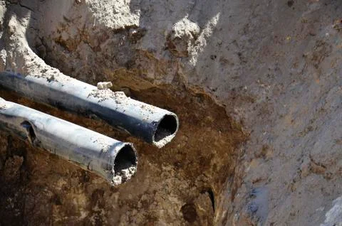 Two metal pipes in the pit. Stock Photos
