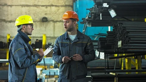 Two metalworkers checking stocks at the factory storage Stock-Footage 89505624
