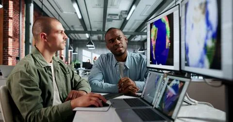 Two Meteorologists Discuss Climate Data On Computers To Predict Hurricanes. Stock Photos