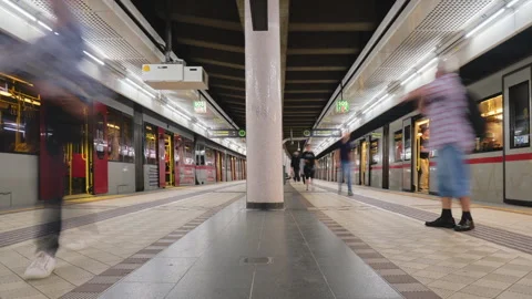Two metro trains arrive and depart simultaneously at underground subway station Stock Footage 252814864