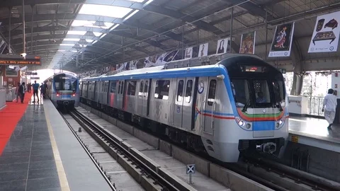 Two metro trains depart a station in India Stock Footage 83193448