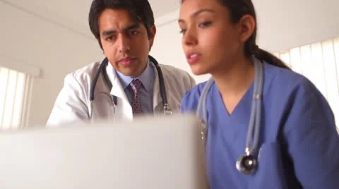 Two Mexican doctors analyzing patient's medical records Stock-Footage 25628685