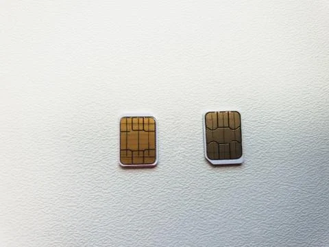 Two micro sim cards on a light background surface Stock Photos
