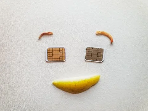 Two micro sim cards lying in the shape of a smiling face Stock Photos