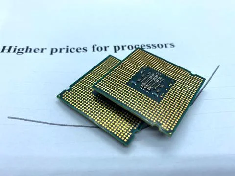 Two microprocessors on a paper written higher prices closeup view Stock Photos