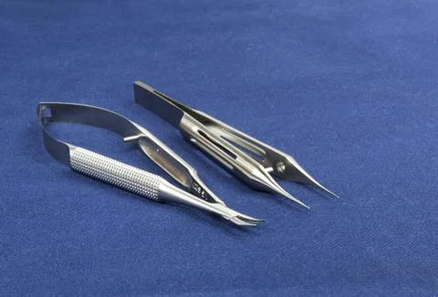 Two microsurgical instruments on blue background Stock Photos