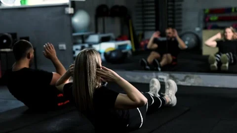 Two middle-aged athletes exercising together in fitness. Stock Footage 313789316