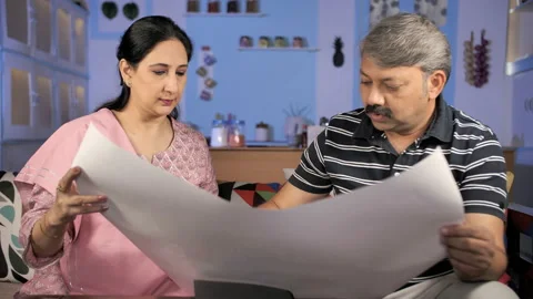 Two middle-aged Indian people planning the interior design of their new house Stock Footage 149477980