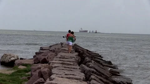 Two middle aged ladies walking on jetty in the water Stock Footage 51418109