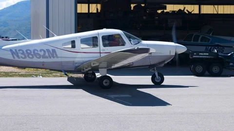 Two middle aged men are sitting in the closed cockpit of light plane Stockbeeldmateriaal 115895075