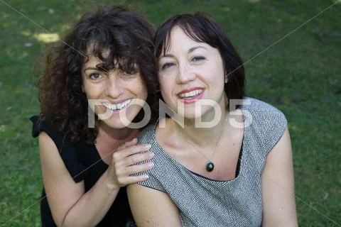 Two middle-aged women outside in a park Stock Photos