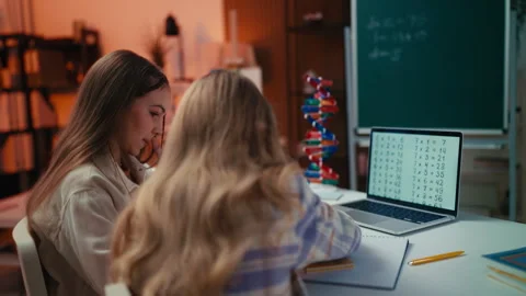 Two middle school students work together solving math equations during a lesson Stock Footage 296039186