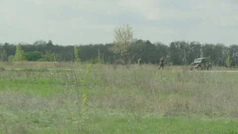 Two militaries are going to the car with weapon. Stock Footage 107794282
