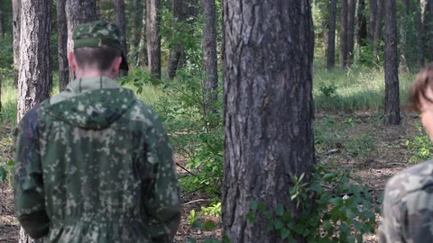Two military men go through the forest, one of them is a prisoner Stockbeeldmateriaal 127907892