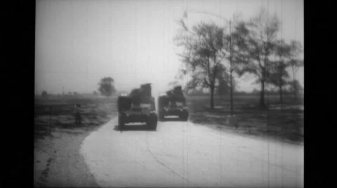 Two military tanks taking a turn on road Stock Footage 39932778