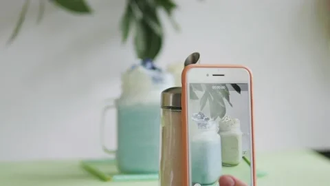 Two milkshakes blue and white stand on a green background. milkshakes on a white Stock-Footage 139859268