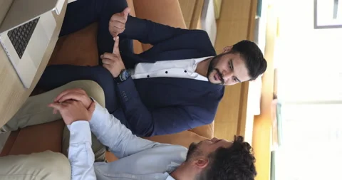 Two millennial multi-ethnic businessmen negotiating in office Stock Footage 249091071