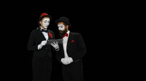 Two mimes dicusses something using tablet computer, alpha channel Stock-Footage 47708128