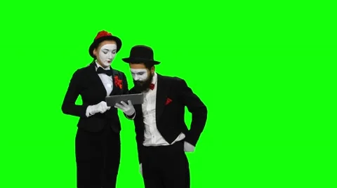 Two mimes watches something using tablet computer on green screen Stock-Footage 47708143