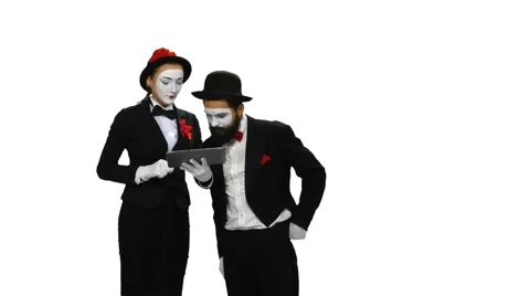 Two mimes watches something using tablet computer on white screen Stock-Footage 47708149