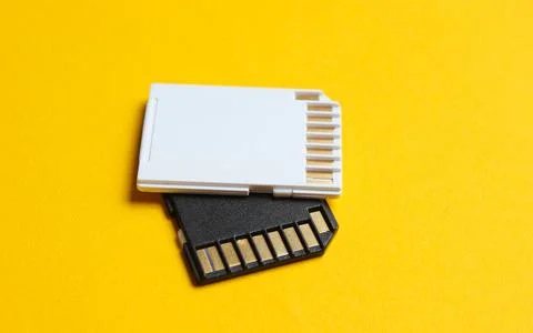 Two Mini SD memory cards on yellow background close up Stockfoto's