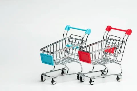 Two mini shopping carts on white surface Stock Photos