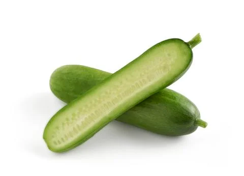 Two mini snack cucumbers one sliced in halve Stock Photos