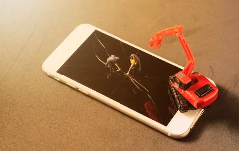 Two miniature worker drilling to the broken damage screen of mobile phone Stock Photos