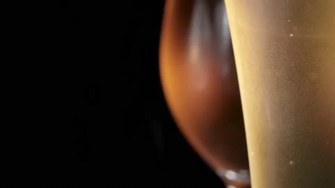 Two misted glass with cold light and dark beer. bubbles. stock footage. Stock Footage 133730982