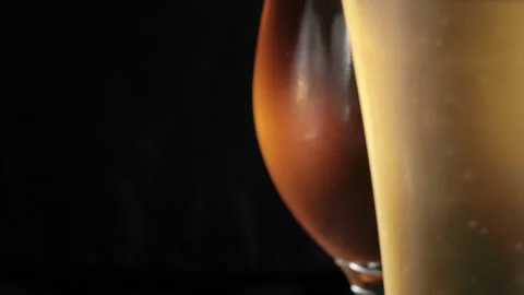 Two misted glass with cold light and dark beer. bubbles. stock footage. Stock Footage 133731263