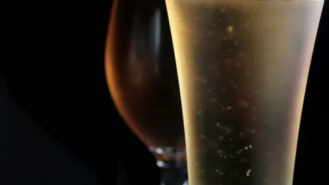 Two misted glass with cold light and dark beer. bubbles. stock footage. Stock Footage 133732502