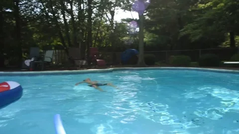 Two mixed boys have a fun in the swimming pool Video stock 136491020