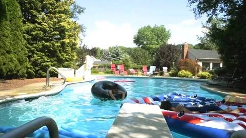 Two mixed boys have a fun in the swimming pool Video stock 136491705