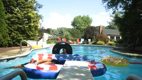 Two mixed boys have a fun in the swimming pool Video stock 136491706