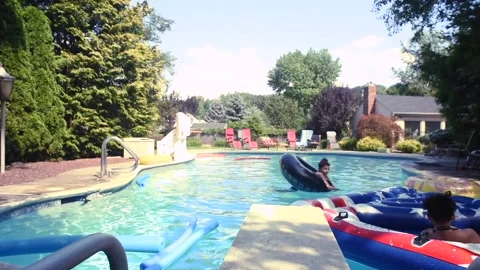 Two mixed boys have a fun in the swimming pool Video stock 136491869