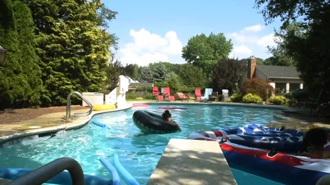 Two mixed boys have a fun in the swimming pool Video stock 136491870