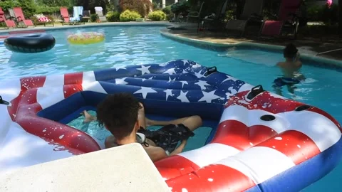 Two mixed boys have a fun in the swimming pool Video stock 136491873