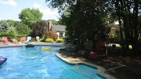 Two mixed boys have a fun in the swimming pool Video stock 136491960