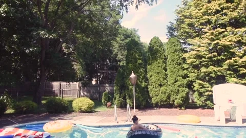 Two mixed boys have a fun in the swimming pool Video stock 136492097