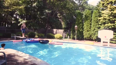 Two mixed boys have a fun in the swimming pool Video stock 136492121