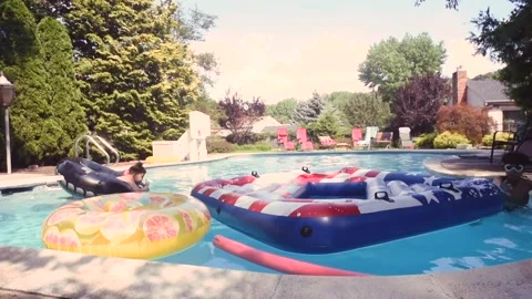 Two mixed boys have a fun in the swimming pool Video stock 136492125