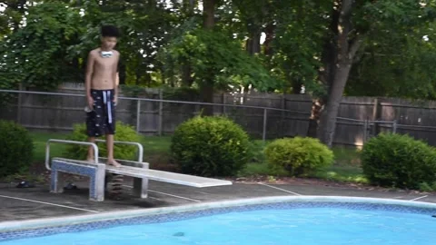 Two mixed boys have a fun in the swimming pool Video stock 136492233