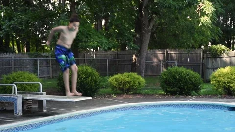 Two mixed boys have a fun in the swimming pool Video stock 136492259