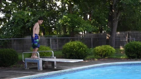 Two mixed boys have a fun in the swimming pool Video stock 136492314