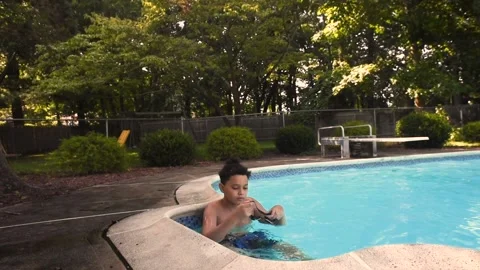 Two mixed boys have a fun in the swimming pool Video stock 136492467