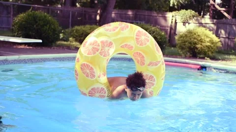 Two mixed boys have a fun in the swimming pool Video stock 136492632