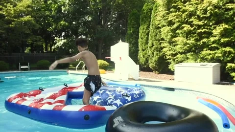 Two mixed boys have a fun in the swimming pool Video stock 136492785
