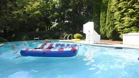 Two mixed boys have a fun in the swimming pool Stock Footage 136492814