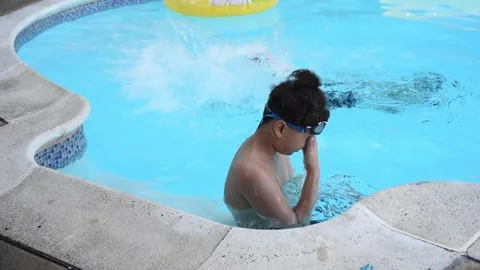 Two mixed boys have a fun in the swimming pool Stock Footage 136493343