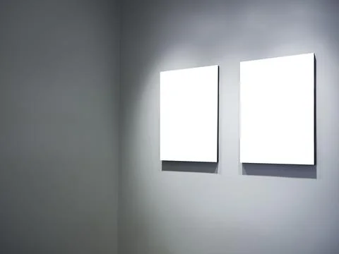 Two mockup vertical rectangle painting frames hanging on white wall backgroun Stock Photos